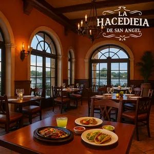 La Hacienda de San Angel dining room with large windows and beamed ceiling, lit up at night