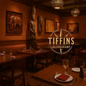 A grilled pork chop with garlic crust on a plate served with cabbage and carrot slaw and corn cake at Tiffins Restaurant
