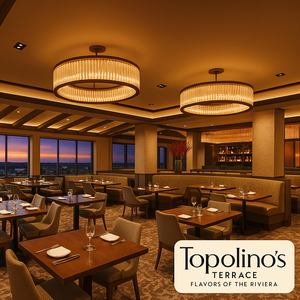 A stylish and modern dining room with large windows revealing a sunset 