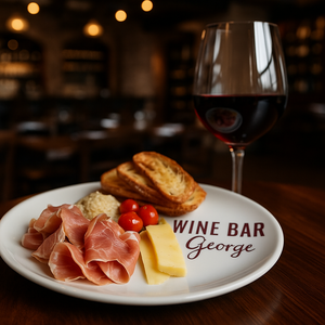 The exterior of Wine Bar George features balcony seating